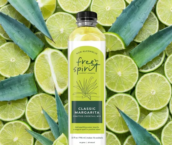 Classic Margarita bottle on a bed of its fresh ingredients